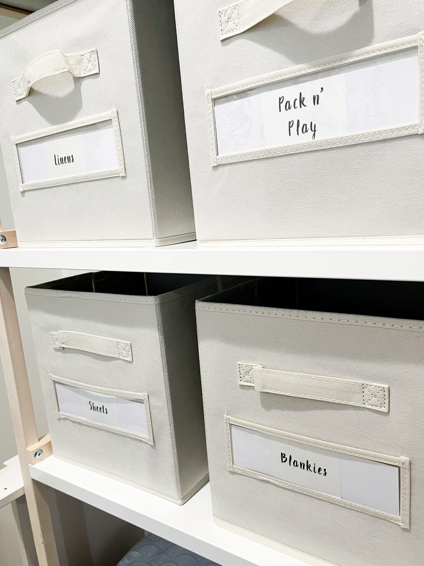 A shelf with four white boxes labeled " pick n play ".