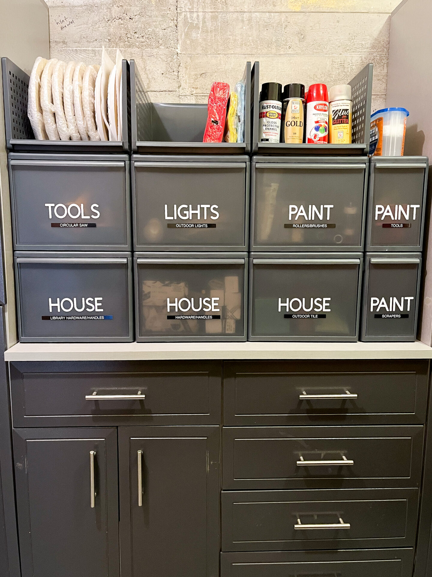 A cabinet with many drawers and different types of paint.