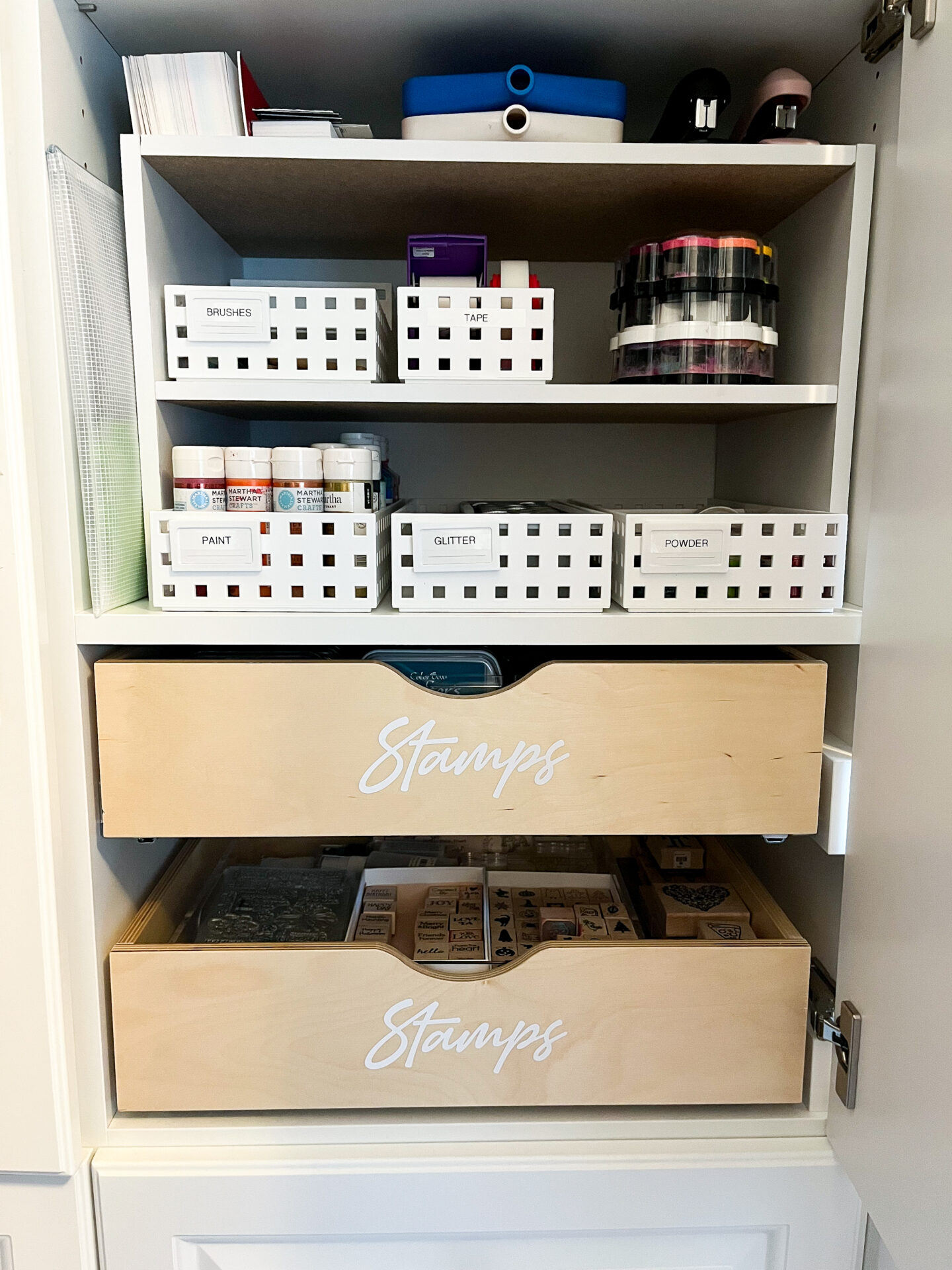 A shelf with many boxes and drawers in it