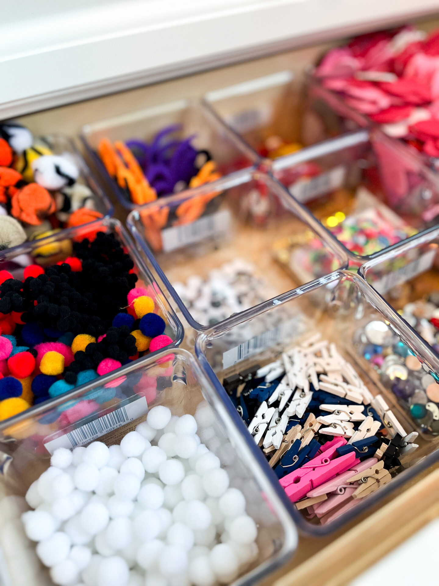 A drawer filled with lots of different colored objects.