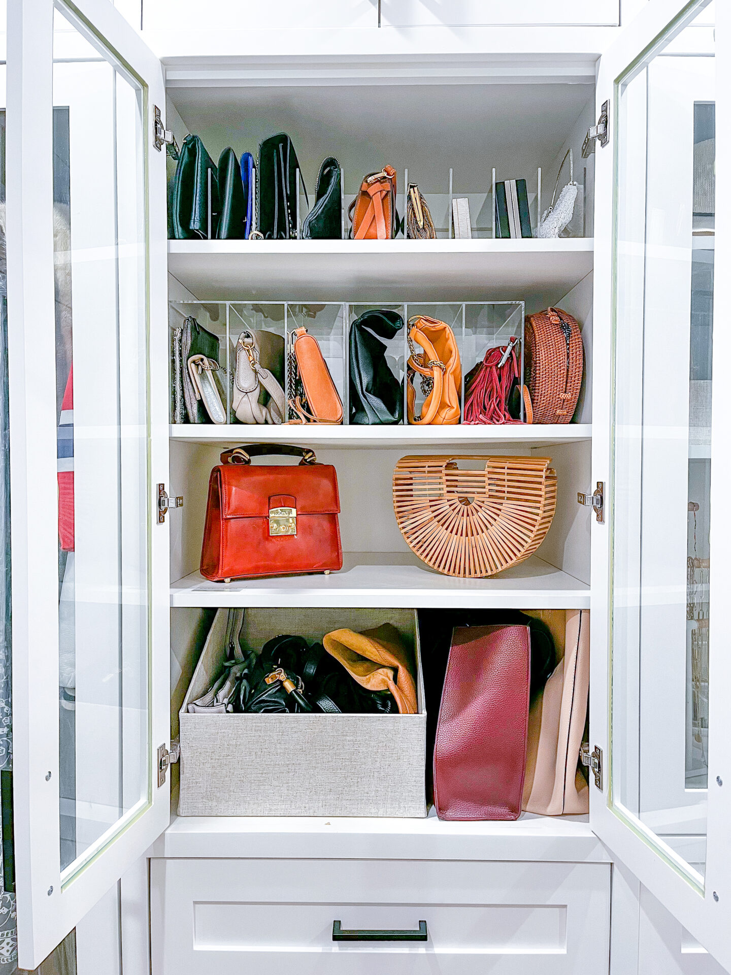 A white cabinet with many purses in it