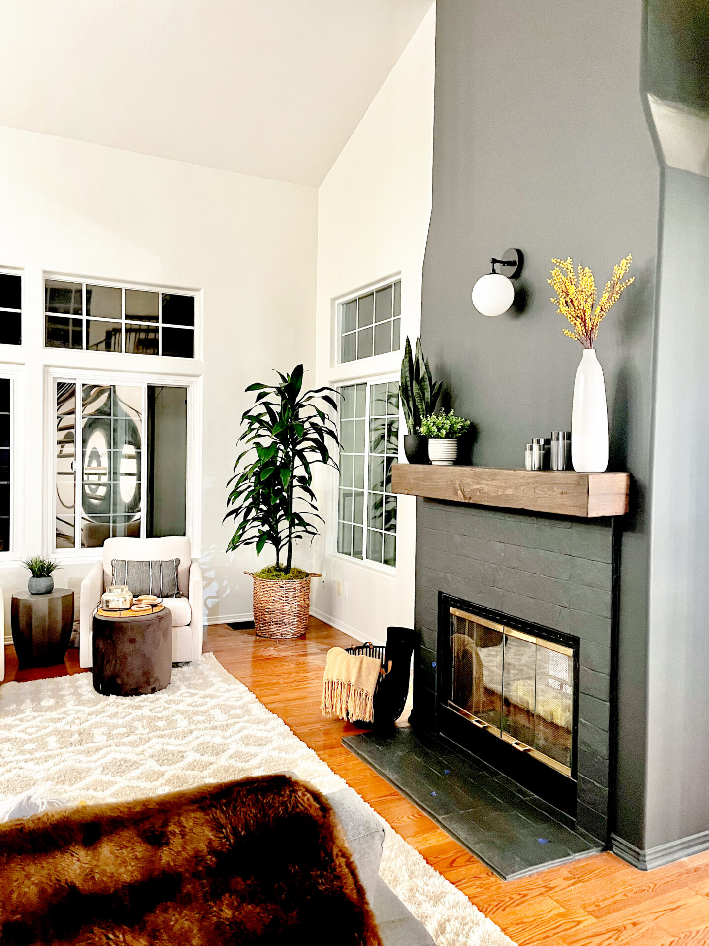 A living room with a fireplace and two chairs